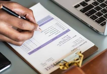 Man with a pen checking a report