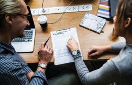 Even if the creditor goes bankrupt, you still need to pay your debts Woman and smiling man pointing out on contract form